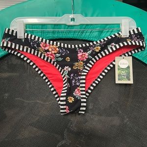 Low rise bikini bottom. Ruched back. Size Medium. New with tags. Black & white